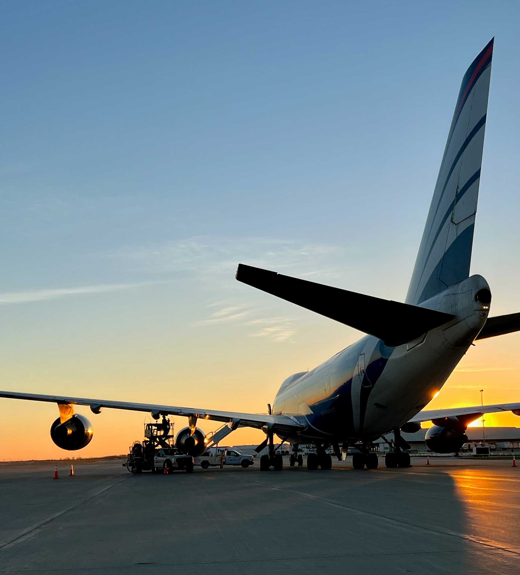 A plane being loaded with cargo on a runway