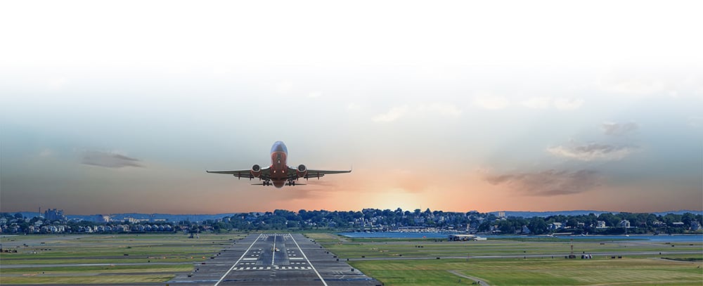an airplane taking off at sunset