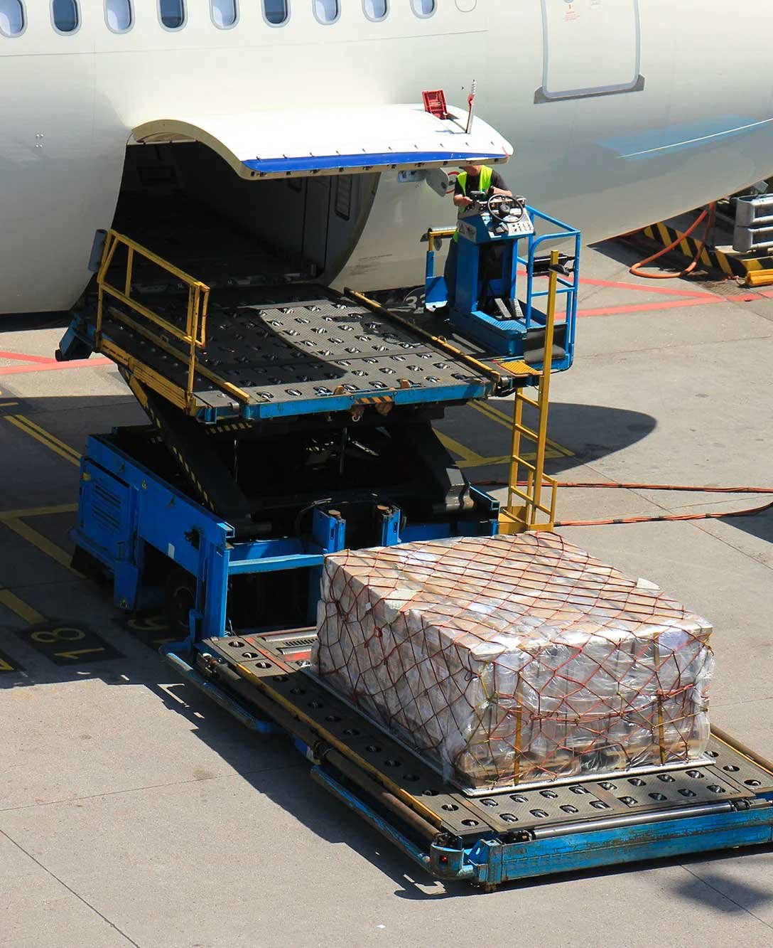workers loading a cargo plane on a tarmac