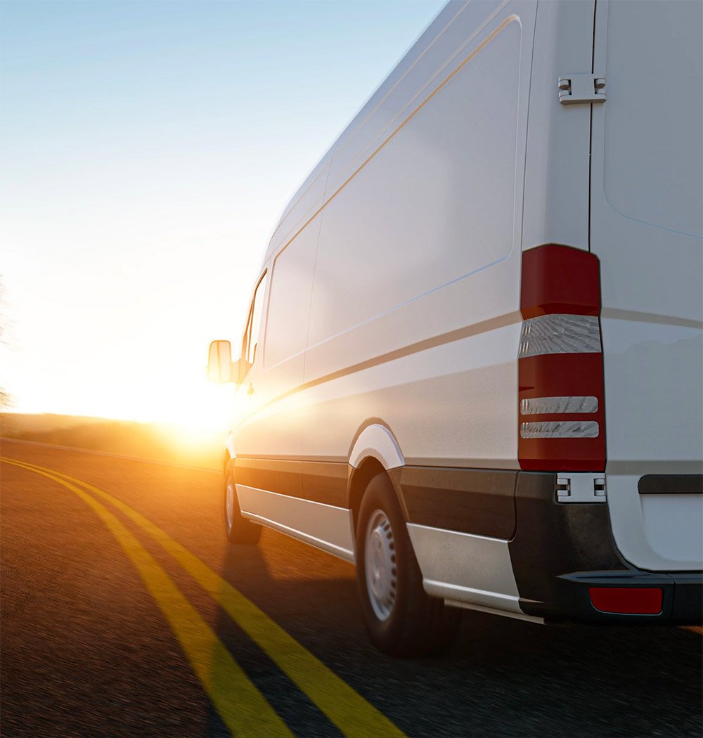 a white sprinter van on the road